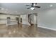 Open living space with hardwood floors, a kitchen, and staircase at 607 Leland Pkwy, Cumming, GA 30041