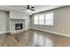 Living room features hardwood floors, a stone fireplace, and large windows at 607 Leland Pkwy, Cumming, GA 30041