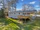 Backyard view of the deck, basement access, carport, and screened-in back porch. Lots of storage at 3784 Robinson Ne Rd, Marietta, GA 30068
