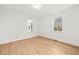 Bedroom featuring wood floors, white walls and two windows overlooking the exterior at 3784 Robinson Ne Rd, Marietta, GA 30068