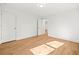 Bedroom features wood floors, white walls and a door to another room at 3784 Robinson Ne Rd, Marietta, GA 30068