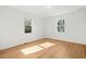 Bedroom featuring wood floors, white walls and two windows overlooking the exterior at 3784 Robinson Ne Rd, Marietta, GA 30068
