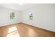 Well-lit bedroom with hardwood floors and two windows at 3784 Robinson Ne Rd, Marietta, GA 30068