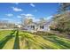 Well-manicured lawn surrounds this charming home with a freshly painted exterior and inviting front porch at 3784 Robinson Ne Rd, Marietta, GA 30068