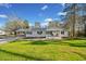 Charming single-story home with a well-maintained lawn, covered parking, and inviting front entrance at 3784 Robinson Ne Rd, Marietta, GA 30068