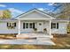 Inviting front porch with white columns and black shuttered windows accents a beautifully landscaped yard at 3784 Robinson Ne Rd, Marietta, GA 30068