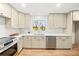 Bright kitchen featuring stainless steel appliances, white countertops, and light-colored cabinetry at 3784 Robinson Ne Rd, Marietta, GA 30068