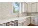 Close-up of kitchen with stainless steel appliances, white cabinets, and a large farmhouse sink under the window at 482 Majestic Oaks Pl, Smyrna, GA 30082