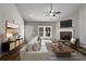 Cozy living room with a stone fireplace, neutral decor, and ample natural light streaming through a large window at Lot 1 Perkins Rd, Dallas, GA 30157