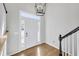 Bright foyer with modern light fixture, hardwood floors, and white front door with glass panels at 108 Sweetbriar Ct, Canton, GA 30115