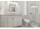 Modern bathroom featuring a tiled shower with glass door and a vanity with storage at 1705 Evans, Atlanta, GA 30310