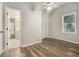 Bedroom with a ceiling fan, wood floor, and lots of natural light from a large window at 1705 Evans, Atlanta, GA 30310
