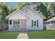 Charming white cottage-style home with a welcoming front porch and well-maintained lawn at 1705 Evans, Atlanta, GA 30310