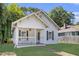 Charming white cottage-style home with a welcoming front porch and well-maintained lawn at 1705 Evans, Atlanta, GA 30310