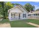 Charming home with white siding, a front porch, and a green lawn at 1705 Evans, Atlanta, GA 30310