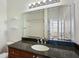 Bathroom with granite countertops, large mirror, and multiple light fixtures at 4254 River Green Nw Dr # 611, Atlanta, GA 30327