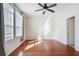 Bright bedroom features hardwood floors, large windows, a ceiling fan, and neutral walls at 4254 River Green Nw Dr # 611, Atlanta, GA 30327