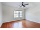 Sun-filled bedroom boasts hardwood floors, a modern ceiling fan, and a large window at 4254 River Green Nw Dr # 611, Atlanta, GA 30327