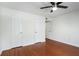 This bedroom has hardwood floors, a ceiling fan, and multiple closets at 4254 River Green Nw Dr # 611, Atlanta, GA 30327