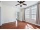 Cozy bedroom features hardwood floors, a ceiling fan, large windows, and neutral walls at 4254 River Green Nw Dr # 611, Atlanta, GA 30327
