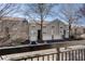 Multi-story townhome complex with grey siding, attached garages, mature trees, and private balconies at 4254 River Green Nw Dr # 611, Atlanta, GA 30327