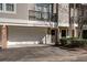 Townhome featuring an attached garage, brick accents, private balcony, and neutral exterior paint at 4254 River Green Nw Dr # 611, Atlanta, GA 30327