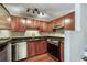 Kitchen with stainless steel appliances, wood cabinets, granite countertops, and track lighting at 4254 River Green Nw Dr # 611, Atlanta, GA 30327