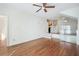 Open-concept living room featuring hardwood floors, modern lighting, staircase, and neutral paint at 4254 River Green Nw Dr # 611, Atlanta, GA 30327