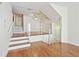 Open living area with hardwood floors, glass railings, and a modern chandelier at 4254 River Green Nw Dr # 611, Atlanta, GA 30327