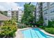 Resort-style pool with sun loungers and landscaping near residential buildings at 4254 River Green Nw Dr # 611, Atlanta, GA 30327