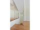 Staircase with hardwood steps, glass railing, and pendant lighting showcasing a modern design at 4254 River Green Nw Dr # 611, Atlanta, GA 30327