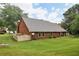 Well maintained brick home featuring a green backyard with a fence and patio at 555 Brickleberry Ln, Roswell, GA 30075