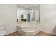 Bathroom with a large soaking tub, vanity mirror, and toilet at 555 Brickleberry Ln, Roswell, GA 30075
