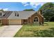 Charming brick home featuring a well-manicured lawn and attached two-car garage at 555 Brickleberry Ln, Roswell, GA 30075