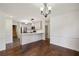 Open-concept kitchen with white cabinets and stainless steel appliances at 555 Brickleberry Ln, Roswell, GA 30075