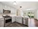 Well-equipped kitchen featuring stainless steel appliances and white countertops at 555 Brickleberry Ln, Roswell, GA 30075