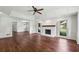 Living room with hardwood floors, fireplace, ceiling fan, and decorative trim at 555 Brickleberry Ln, Roswell, GA 30075