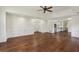 Open-concept living room with hardwood floors and decorative wall paneling at 555 Brickleberry Ln, Roswell, GA 30075