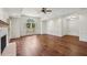 Spacious living room featuring hardwood floors, a ceiling fan and a fireplace at 555 Brickleberry Ln, Roswell, GA 30075