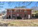 Brick two-story home with a level backyard, patio, and outdoor seating at 1210 Stoneybrook Rd, Forest Park, GA 30297