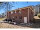 Two-story brick home backyard featuring a patio, grill, and mature trees at 1210 Stoneybrook Rd, Forest Park, GA 30297