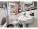 Well-maintained bathroom featuring black and white tiles, pedestal sink, and a framed mirror at 1210 Stoneybrook Rd, Forest Park, GA 30297