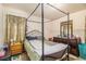 Bedroom featuring a metal-framed canopy bed, dresser, and coordinated curtains at 1210 Stoneybrook Rd, Forest Park, GA 30297