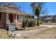 Traditional brick home with a small porch, landscaping and a concrete walkway at 1210 Stoneybrook Rd, Forest Park, GA 30297