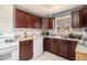 Efficient kitchen with classic wood cabinets, tile backsplash, and modern appliances at 1210 Stoneybrook Rd, Forest Park, GA 30297