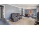 Cozy living room featuring ample seating space and wall-to-wall carpeting at 1210 Stoneybrook Rd, Forest Park, GA 30297