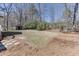 Large backyard with mature trees, a shed, and plenty of space for outdoor activities at 2222 Ivy Crest Dr, Buford, GA 30519