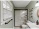 Updated bathroom featuring glass enclosed shower and convenient storage shelves at 2222 Ivy Crest Dr, Buford, GA 30519