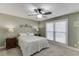 Well-lit bedroom featuring a bed, matching nightstands, and natural light from the window at 2222 Ivy Crest Dr, Buford, GA 30519