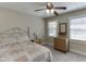 Comfortable bedroom with a ceiling fan and natural light from two windows at 2222 Ivy Crest Dr, Buford, GA 30519